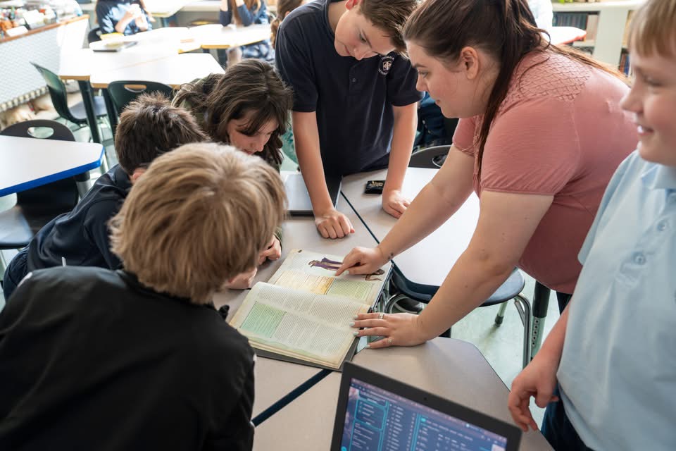 Saint Thomas More teacher and students in the classroom