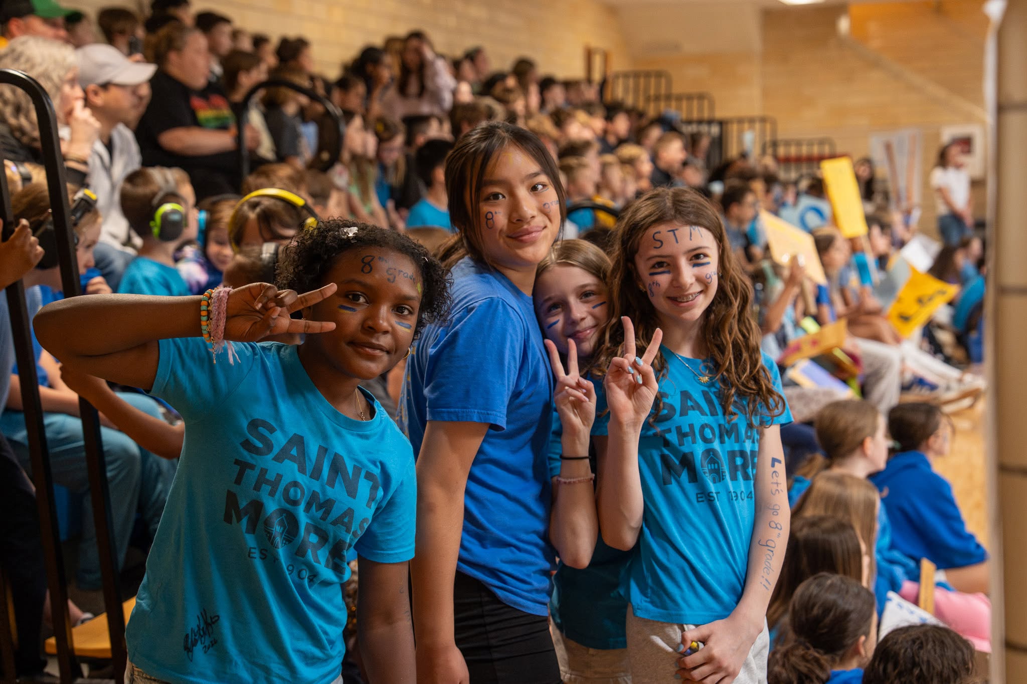 Girls smiling at camera during volleyball game
